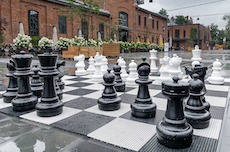 A street chess and a building with red bricks behind it
