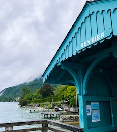 A blue pontoon on a lake