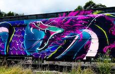 Street art of a dragon on an abandoned train